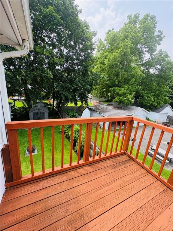 216 W William St Unit 201, Corning-City, NY 14830 - wooden deck featuring a storage unit and a fenced backyard
