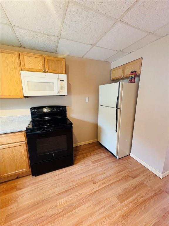 216 W William St Unit 201, Corning-City, NY 14830 - kitchen featuring white appliances, a drop ceiling, light countertops, and light wood-style flooring