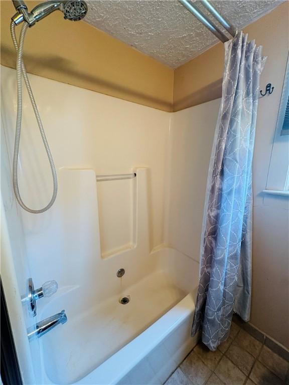 216 W William St Unit 201, Corning-City, NY 14830 - bathroom featuring a textured ceiling and shower / bathtub combination with curtain