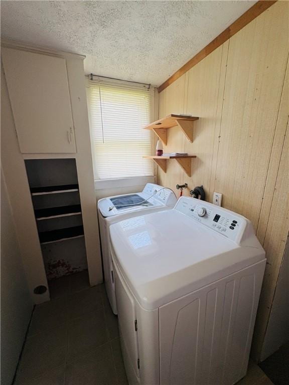 216 W William St Unit 201, Corning-City, NY 14830 - washroom with independent washer and dryer, a textured ceiling, wooden walls, and dark tile patterned flooring