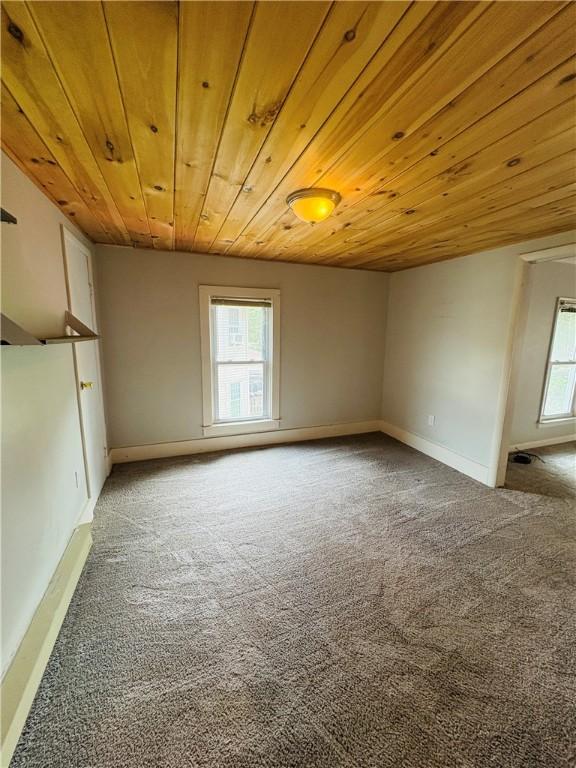216 W William St Unit 201, Corning-City, NY 14830 - unfurnished room featuring carpet, healthy amount of natural light, and wooden ceiling