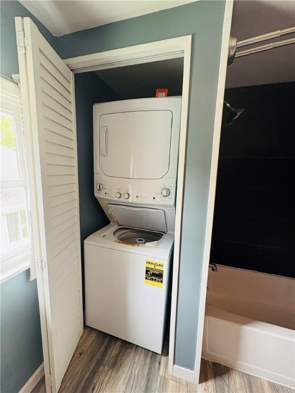216 W William St Unit 201, Corning-City, NY 14830 - laundry room featuring stacked washer / dryer and wood finished floors