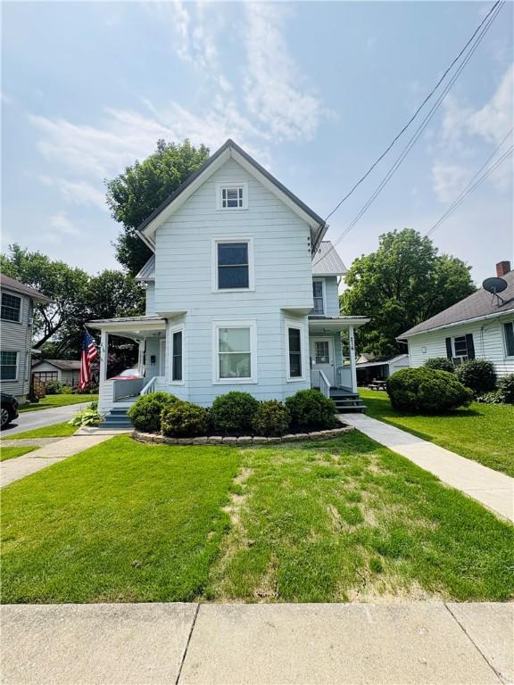 216 W William St Unit 201, Corning-City, NY 14830 - view of front of property with a porch and a front yard
