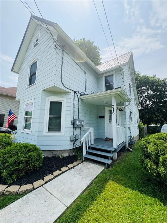 216 W William St Unit 201, Corning-City, NY 14830 - view of front of property with a front lawn, a metal roof, and a standing seam roof