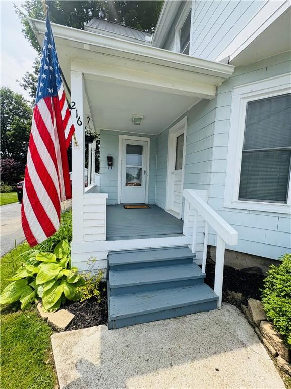 216 W William St Unit 201, Corning-City, NY 14830 - doorway to property featuring covered porch