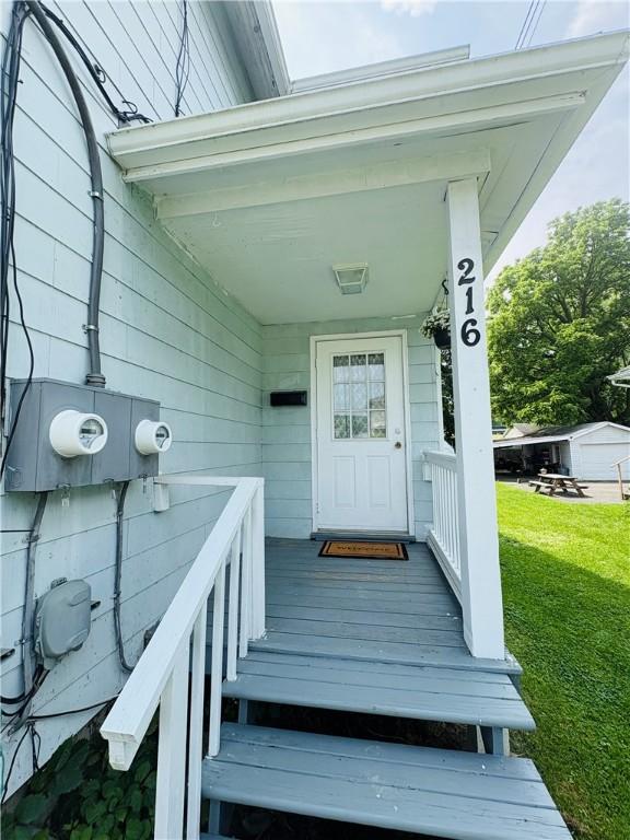 216 W William St Unit 201, Corning-City, NY 14830 - doorway to property featuring a lawn