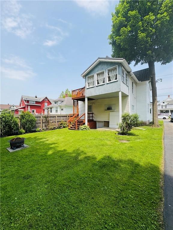 216 W William St Unit 201, Corning-City, NY 14830 - rear view of house with an outdoor fire pit, a deck, and stairs