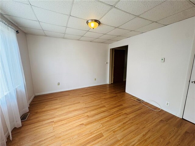 216 W William St Unit 201, Corning-City, NY 14830 - empty room featuring a drop ceiling and light wood-style flooring
