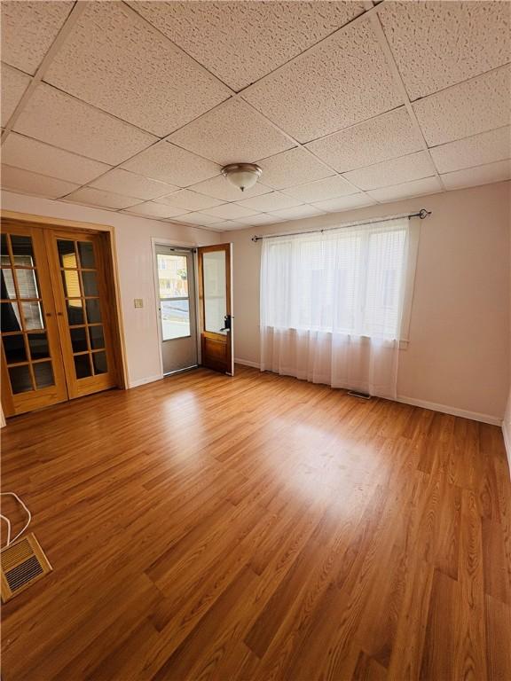 216 W William St Unit 201, Corning-City, NY 14830 - unfurnished room with a paneled ceiling and wood finished floors