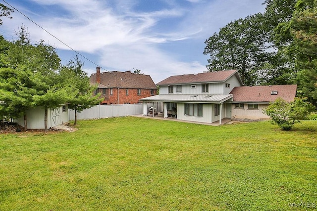 425 Vanderbilt Ave, Niagara Falls, NY 14305 - rear view of property featuring a patio, a metal roof, and a storage shed