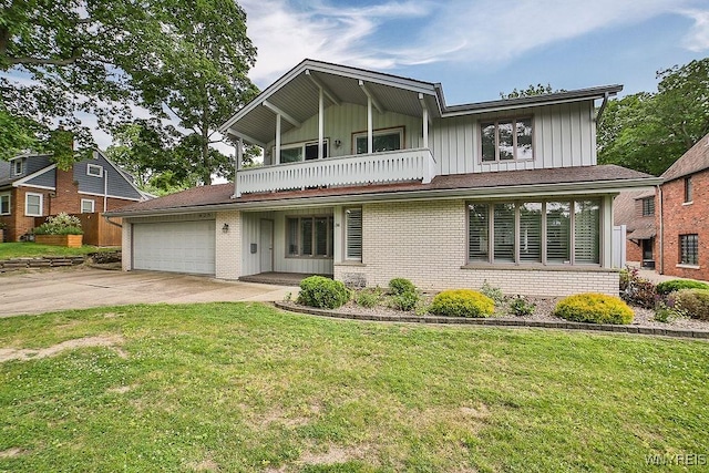 425 Vanderbilt Ave, Niagara Falls, NY 14305 - view of front facade with a balcony, board and batten siding, a garage, and a front lawn
