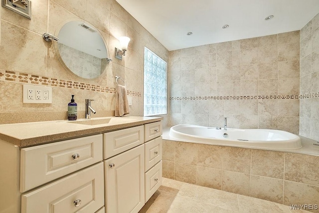 425 Vanderbilt Ave, Niagara Falls, NY 14305 - bathroom with tile walls, vanity, a garden tub, tile patterned floors, and tasteful backsplash