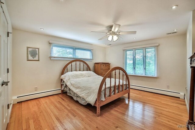 425 Vanderbilt Ave, Niagara Falls, NY 14305 - bedroom featuring a baseboard heating unit, light wood-style flooring, a ceiling fan, and recessed lighting