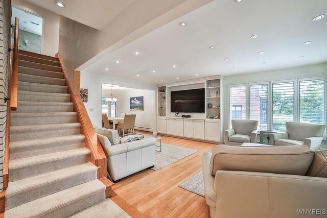 425 Vanderbilt Ave, Niagara Falls, NY 14305 - living room featuring healthy amount of natural light, stairs, recessed lighting, light wood-style floors, and a baseboard heating unit