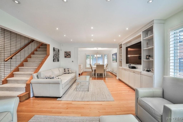425 Vanderbilt Ave, Niagara Falls, NY 14305 - living room featuring light wood-style flooring, a chandelier, stairs, a baseboard heating unit, and recessed lighting