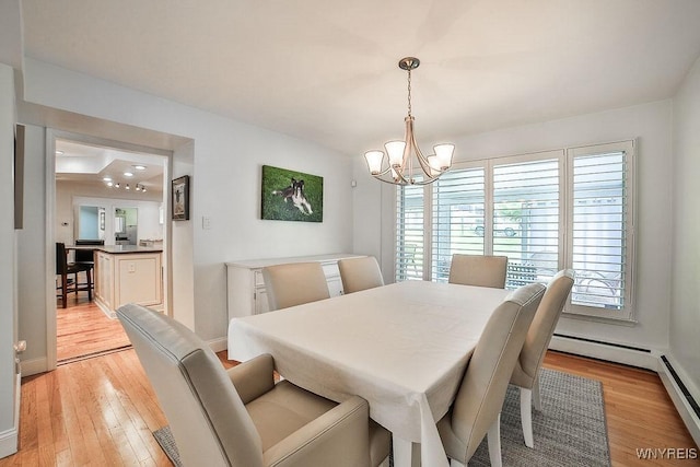 425 Vanderbilt Ave, Niagara Falls, NY 14305 - dining area featuring a chandelier, light wood finished floors, and baseboard heating