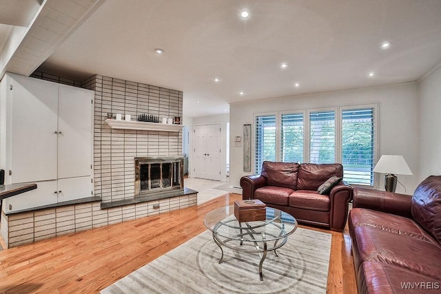 425 Vanderbilt Ave, Niagara Falls, NY 14305 - living room with wood finished floors, recessed lighting, and a brick fireplace