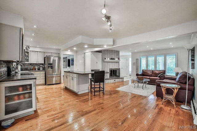 425 Vanderbilt Ave, Niagara Falls, NY 14305 - kitchen with appliances with stainless steel finishes, dark countertops, gray cabinetry, a breakfast bar area, and tasteful backsplash