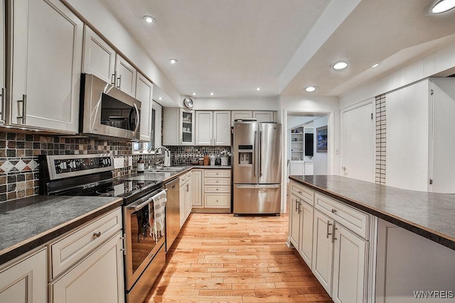 425 Vanderbilt Ave, Niagara Falls, NY 14305 - kitchen featuring appliances with stainless steel finishes, dark countertops, recessed lighting, and light wood-type flooring