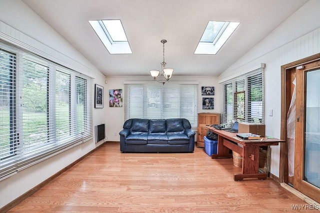 425 Vanderbilt Ave, Niagara Falls, NY 14305 - living area featuring a skylight, vaulted ceiling, a chandelier, and light wood finished floors
