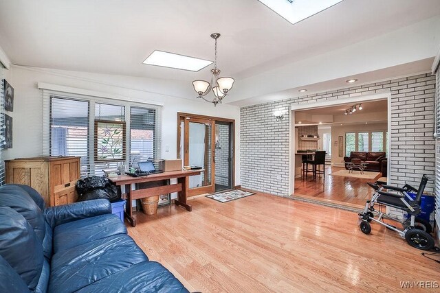 425 Vanderbilt Ave, Niagara Falls, NY 14305 - office space featuring wood finished floors, a chandelier, brick wall, and a skylight