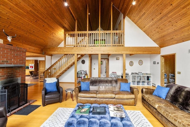 8 Small Rd, Middletown, NY 12455 - living room with high vaulted ceiling, wood ceiling, stairway, wood finished floors, and a fireplace