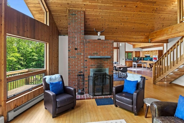 8 Small Rd, Middletown, NY 12455 - living room with a baseboard radiator, healthy amount of natural light, wooden ceiling, light wood-style flooring, and high vaulted ceiling