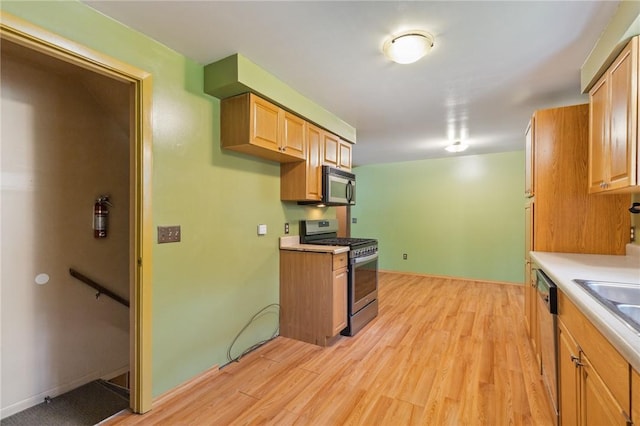 130 Quay Dr, Irondequoit, NY 14617 - kitchen with stainless steel appliances, light wood-style flooring, and light countertops