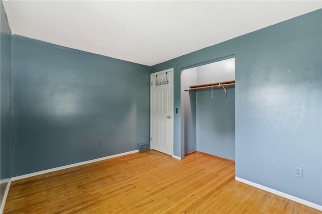 130 Quay Dr, Irondequoit, NY 14617 - unfurnished bedroom featuring wood finished floors and a closet