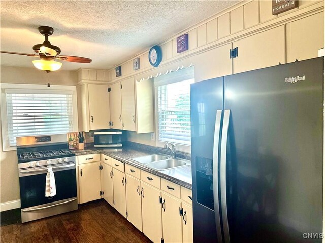 407 Pleasant St, Utica, NY 13501 - kitchen featuring appliances with stainless steel finishes, dark wood-style floors, ceiling fan, a textured ceiling, and dark countertops