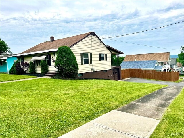 407 Pleasant St, Utica, NY 13501 - view of side of property featuring a garage, a chimney, and driveway