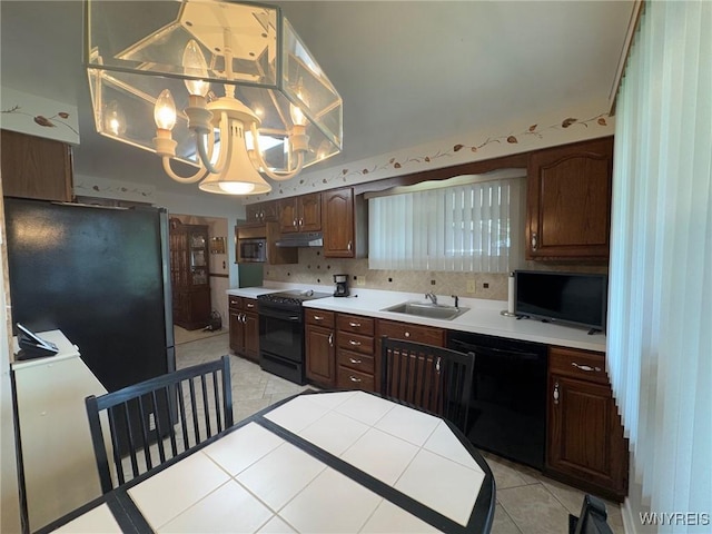 66 Fairlane Ave, Tonawanda-Town, NY 14150 - kitchen featuring black appliances, a chandelier, light tile patterned floors, tile counters, and decorative backsplash