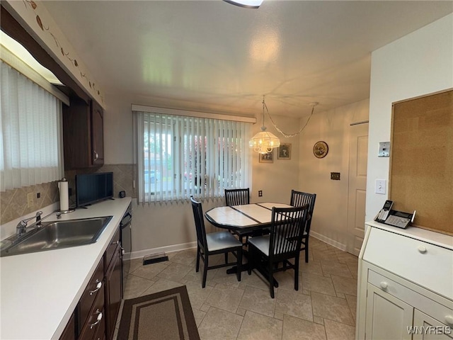 66 Fairlane Ave, Tonawanda-Town, NY 14150 - dining space with a chandelier and baseboards