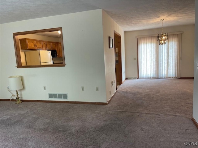 201 Sayles St, Oneida-Inside, NY 13421 - empty room featuring carpet floors, a chandelier, and a textured ceiling