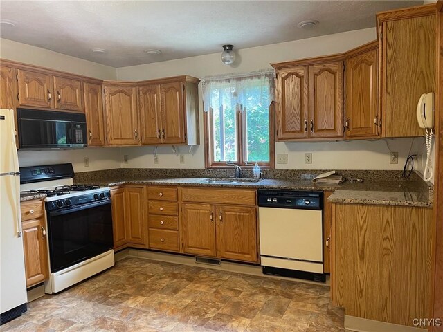 201 Sayles St, Oneida-Inside, NY 13421 - kitchen featuring white appliances, brown cabinets, and stone finish floors