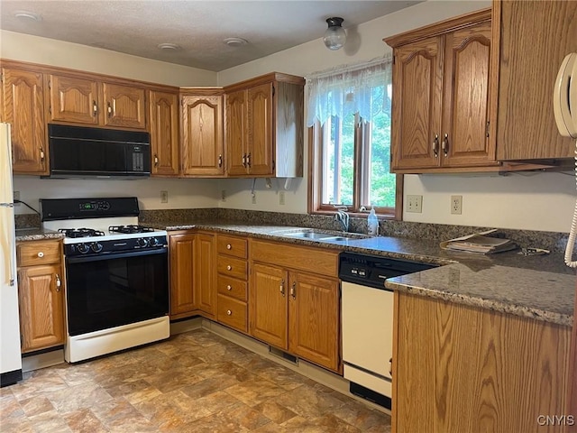 201 Sayles St, Oneida-Inside, NY 13421 - kitchen with white appliances, brown cabinets, and stone finish floors