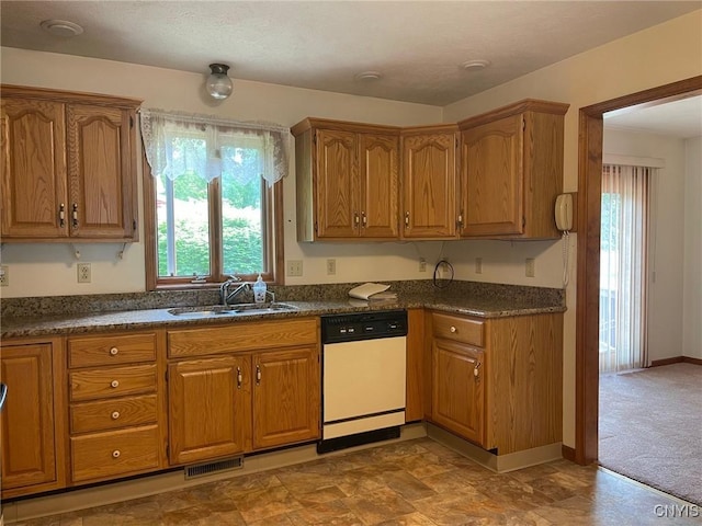 201 Sayles St, Oneida-Inside, NY 13421 - kitchen with dishwasher, plenty of natural light, and brown cabinetry