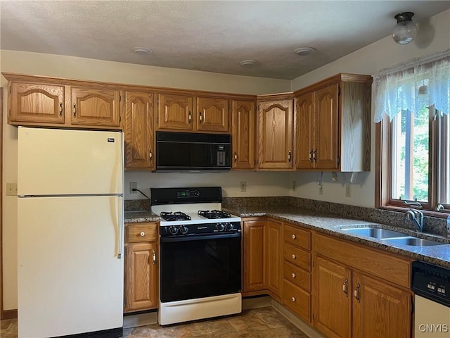 201 Sayles St, Oneida-Inside, NY 13421 - kitchen with freestanding refrigerator, black microwave, gas range oven, dishwashing machine, and brown cabinetry
