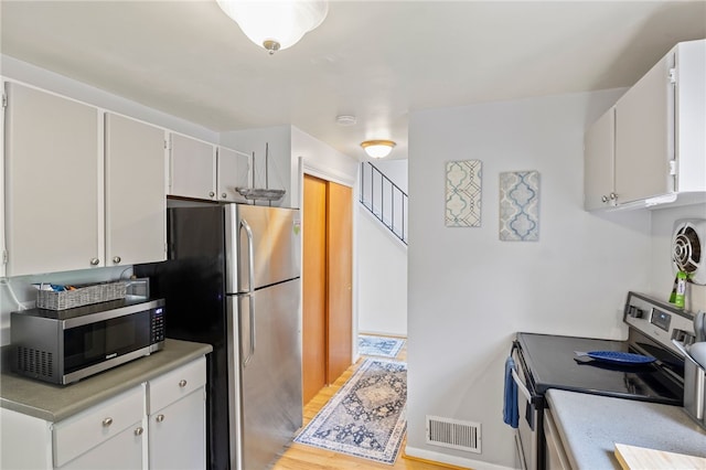 3 Harbour Ln, South Bristol, NY 14424 - kitchen with stainless steel appliances, light countertops, light wood-style flooring, and white cabinets