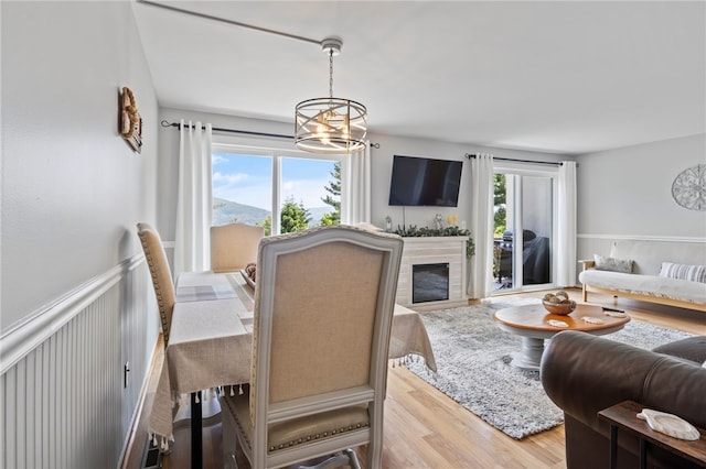 3 Harbour Ln, South Bristol, NY 14424 - dining area featuring a chandelier, wood finished floors, and a fireplace