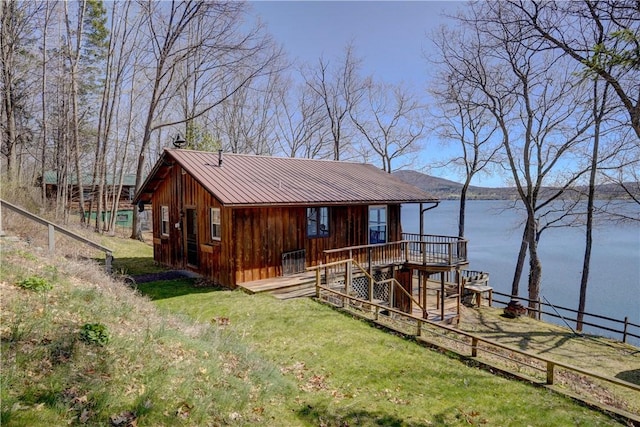 6121 Beechtree Dr, South Bristol, NY 14512 - view of front facade with a deck with water view, a metal roof, and stairs