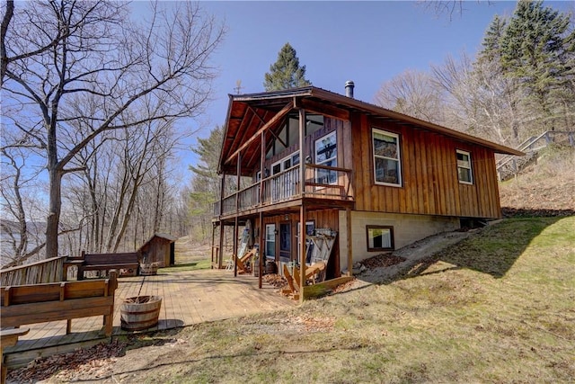 6121 Beechtree Dr, South Bristol, NY 14512 - rear view of house featuring an outdoor structure, a deck, a patio, and a lawn