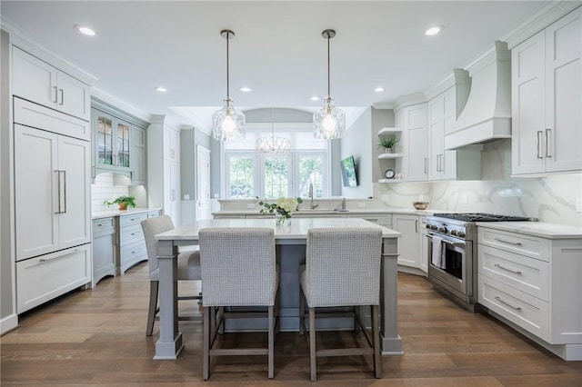15 Cathedral Oaks, Perinton, NY 14450 - kitchen featuring high end appliances, custom range hood, open shelves, a center island, and light countertops