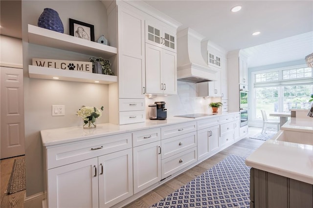 15 Cathedral Oaks, Perinton, NY 14450 - kitchen with light wood-style floors, white cabinetry, open shelves, stainless steel double oven, and recessed lighting