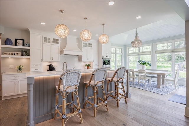 15 Cathedral Oaks, Perinton, NY 14450 - kitchen featuring custom exhaust hood, oven, light countertops, white cabinetry, and recessed lighting