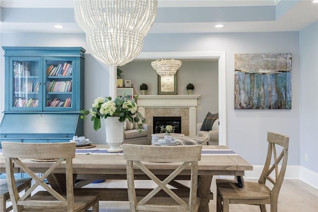 15 Cathedral Oaks, Perinton, NY 14450 - dining area featuring light wood finished floors, a chandelier, recessed lighting, and a fireplace