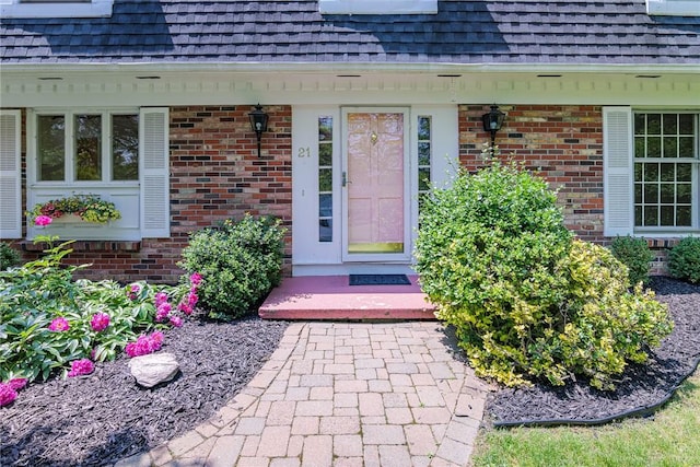 21 Chipping, Perinton, NY 14450 - view of exterior entry with a shingled roof and brick siding