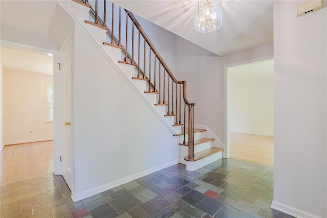 21 Chipping, Perinton, NY 14450 - stairway featuring stone tile floors and a chandelier