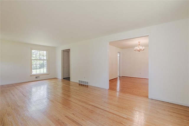 21 Chipping, Perinton, NY 14450 - empty room with a chandelier and light wood-style flooring