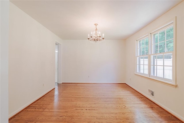 21 Chipping, Perinton, NY 14450 - spare room with a chandelier and light wood-type flooring